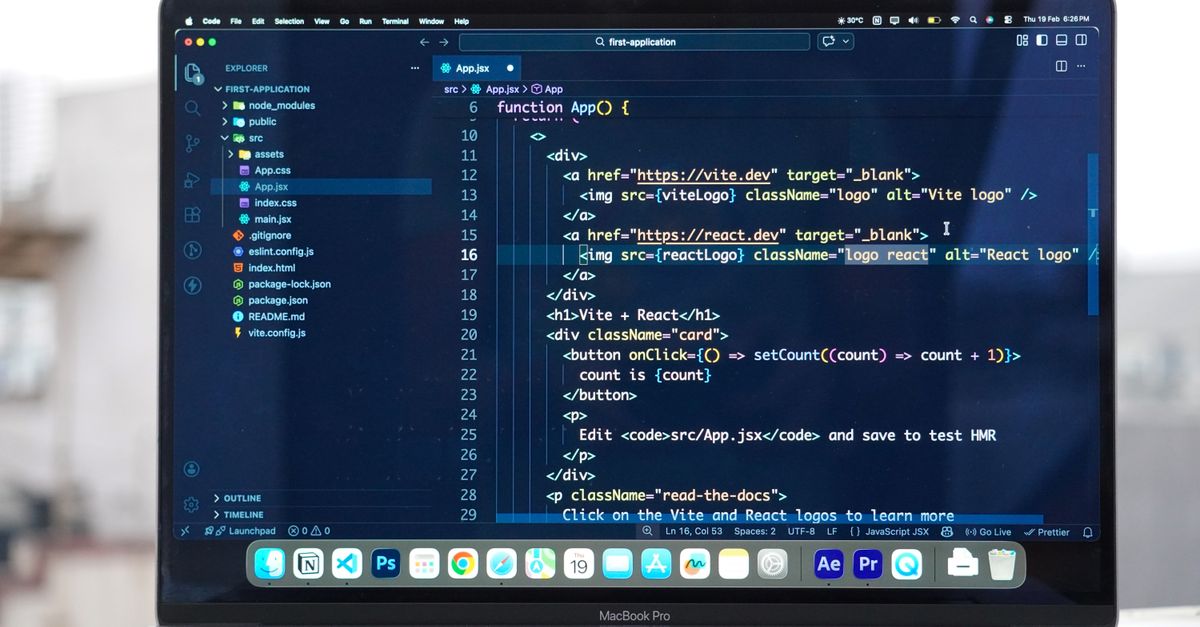 Laptop with code editor open on a rooftop, showcasing remote web development and modern work flexibility.
